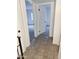 Hallway with tile flooring leading to carpeted bedrooms with white doors and trim at 5975 N 48Th Dr, Glendale, AZ 85301