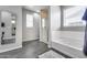 Bathroom features dark tiled floors, tub, shower, and decorative mirror at 631 W Winchester Dr, Chandler, AZ 85286