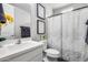 Modern bathroom features a decorative shower curtain, framed art, and grey towels at 631 W Winchester Dr, Chandler, AZ 85286