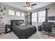 Comfortable bedroom featuring a dark bed, coordinated furniture, and plenty of natural light, creating a relaxing retreat at 631 W Winchester Dr, Chandler, AZ 85286