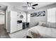 Bedroom features a ceiling fan, mini-fridge, and beverage center in the cabinets at 631 W Winchester Dr, Chandler, AZ 85286