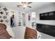 Large bedroom boasts ceiling fan, carpeted floors, TV, closet and attached bathroom at 631 W Winchester Dr, Chandler, AZ 85286