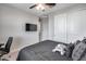 This bedroom offers neutral walls, ceiling fan, TV, and sliding door closet at 631 W Winchester Dr, Chandler, AZ 85286