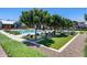 Relaxing community pool area with lounge chairs, umbrellas and manicured greenery at 631 W Winchester Dr, Chandler, AZ 85286