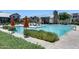 Sparkling community pool with lounge chairs and umbrellas for relaxation at 631 W Winchester Dr, Chandler, AZ 85286
