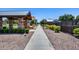 Scenic community walkway surrounded by lush landscaping, playground, and homes at 631 W Winchester Dr, Chandler, AZ 85286