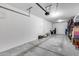 Spacious two-car garage with white walls, and concrete floor at 631 W Winchester Dr, Chandler, AZ 85286