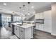Modern kitchen with large island, barstool seating, stainless appliances, and an open floor plan at 631 W Winchester Dr, Chandler, AZ 85286