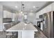 Spacious modern kitchen with large island, stainless steel appliances, and white cabinetry at 631 W Winchester Dr, Chandler, AZ 85286