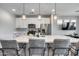 Kitchen featuring an island with seating, pendant lighting, and stainless steel appliances at 631 W Winchester Dr, Chandler, AZ 85286