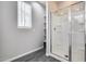 Bathroom features a shower with a glass door, and light grey walls at 631 W Winchester Dr, Chandler, AZ 85286