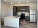 Modern kitchen with a center island, stainless steel appliances, and ample cabinet space at 640 S Maricopa Rd, Florence, AZ 85132