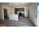 Stylish kitchen with stainless steel appliances, an island, and gray cabinets and countertops at 640 S Maricopa Rd, Florence, AZ 85132
