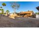 Backyard view featuring a covered patio, block wall, gravel groundcover and mature landscaping at 6424 E Aire Libre Ln, Scottsdale, AZ 85254