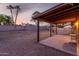 The backyard with a covered patio is surrounded by palm trees at 6424 E Aire Libre Ln, Scottsdale, AZ 85254