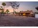 A spacious gravel backyard with a covered patio, perfect for entertaining and relaxing outdoors at 6424 E Aire Libre Ln, Scottsdale, AZ 85254