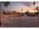 A large, gravel-covered backyard with a covered patio, and an outdoor area at 6424 E Aire Libre Ln, Scottsdale, AZ 85254