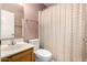 Bathroom featuring a tiled shower and bathtub, a wooden vanity, and a toilet at 6424 E Aire Libre Ln, Scottsdale, AZ 85254