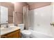 Bathroom featuring a tiled shower and bathtub, a wooden vanity, and a toilet at 6424 E Aire Libre Ln, Scottsdale, AZ 85254