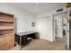 Bedroom with light-colored walls, neutral carpet, closet with sliding doors, and a study desk at 6424 E Aire Libre Ln, Scottsdale, AZ 85254