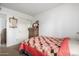 Bedroom with carpet flooring, a bed with a patterned quilt, and access to a closet at 6424 E Aire Libre Ln, Scottsdale, AZ 85254