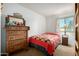 Bedroom with a carpet flooring, a metal-framed bed, and a wooden dresser at 6424 E Aire Libre Ln, Scottsdale, AZ 85254