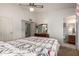 Bedroom featuring neutral walls, ceiling fan, and a doorway to the bathroom at 6424 E Aire Libre Ln, Scottsdale, AZ 85254