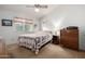 Bright bedroom with neutral walls, ceiling fan, carpet flooring, and a window at 6424 E Aire Libre Ln, Scottsdale, AZ 85254