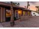 Inviting front entrance with a decorative screen door and warm exterior lighting at 6424 E Aire Libre Ln, Scottsdale, AZ 85254