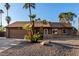 Inviting single-story home featuring desert landscaping, complemented by mature palms at 6424 E Aire Libre Ln, Scottsdale, AZ 85254