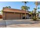 Single-story home featuring desert landscaping, large driveway and a two-car garage at 6424 E Aire Libre Ln, Scottsdale, AZ 85254
