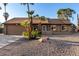 Attractive single-story home with desert landscaping and beautiful mature palm trees at 6424 E Aire Libre Ln, Scottsdale, AZ 85254