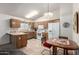 Bright eat-in kitchen with white appliances, wood cabinets, and tile flooring at 6424 E Aire Libre Ln, Scottsdale, AZ 85254