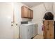 This utility room includes a washer, dryer, and built-in storage for convenience at 6424 E Aire Libre Ln, Scottsdale, AZ 85254