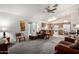 Living room features an open layout, carpet, and kitchen access at 6424 E Aire Libre Ln, Scottsdale, AZ 85254