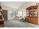Comfortable living room with carpeted floors, a sofa, and a charming display cabinet at 6424 E Aire Libre Ln, Scottsdale, AZ 85254