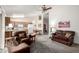 Bright living room with carpet and access to kitchen with wood cabinets at 6424 E Aire Libre Ln, Scottsdale, AZ 85254