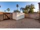 Backyard view with a white metal storage shed against a privacy wall amid gravel groundcover at 6424 E Aire Libre Ln, Scottsdale, AZ 85254