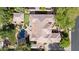 Aerial view of the house showcasing the pool with waterfall, backyard landscaping, and roof at 6428 W Eugie Ave, Glendale, AZ 85304