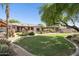 Expansive backyard featuring lush green lawn, mature trees, covered patio, and a charming gazebo at 6428 W Eugie Ave, Glendale, AZ 85304