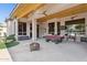 Expansive covered patio with pool table, fire pit, and outdoor TVs for entertaining in the backyard at 6428 W Eugie Ave, Glendale, AZ 85304