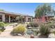 Lush backyard showcasing an outdoor living space with a charming pond and desert landscaping at 6428 W Eugie Ave, Glendale, AZ 85304