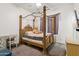 Bedroom featuring a four-post bed and a plush teddy bear at 6428 W Eugie Ave, Glendale, AZ 85304