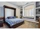Cozy bedroom with built-in shelving, window seat, and blue accents at 6428 W Eugie Ave, Glendale, AZ 85304