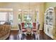 Elegant dining room with a chandelier, a glass table, and backyard views through expansive windows at 6428 W Eugie Ave, Glendale, AZ 85304
