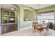 Cozy dining area with large window and open view to the living room with built in shelving at 6428 W Eugie Ave, Glendale, AZ 85304