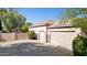 Exterior features a multi-car garage, a covered patio, and driveway at 6428 W Eugie Ave, Glendale, AZ 85304