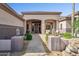 Inviting front porch with neutral furniture, stone pathway, and manicured landscaping at 6428 W Eugie Ave, Glendale, AZ 85304