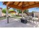 Charming covered gazebo area in a large backyard with manicured lawn and outdoor seating at 6428 W Eugie Ave, Glendale, AZ 85304