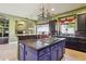 Well-equipped kitchen with central island cooktop, and ample counter space at 6428 W Eugie Ave, Glendale, AZ 85304